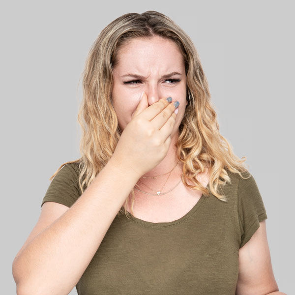 woman holding her nose